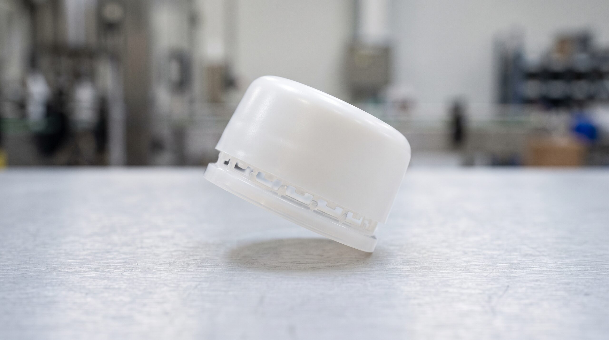 タンパーエビデンスバンド付きの白いプラスチックキャップのクローズアップ